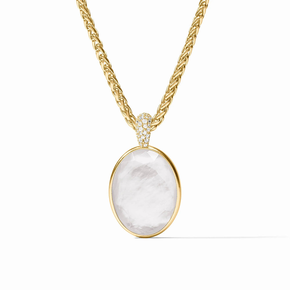 A gold pendant necklace featuring a large oval clear stone in a gold bezel setting, suspended from a twisted gold chain with a small pavé accent at the top, shown on a clean white background.