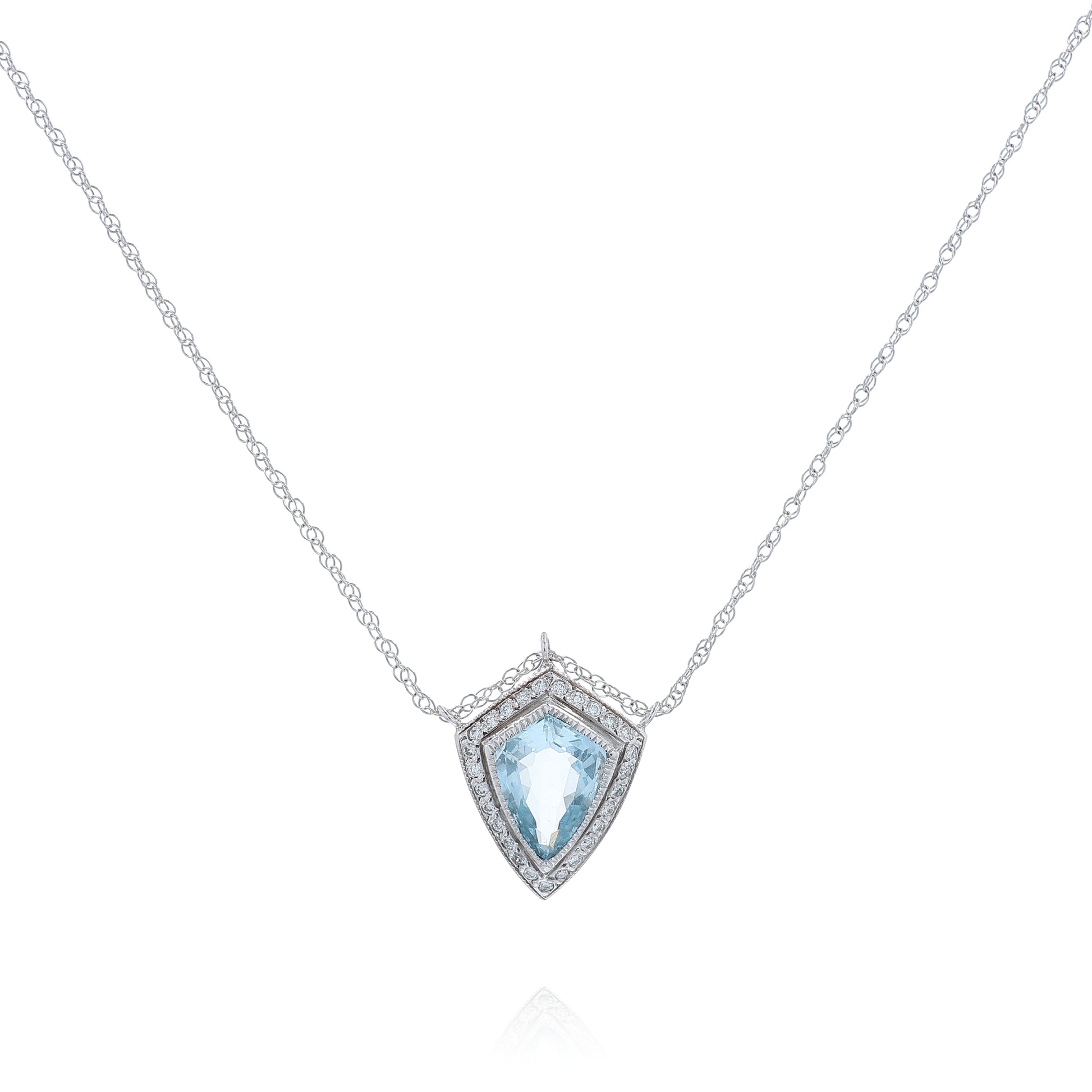 White gold shield cut aquamarine and diamond halo pendant necklace on a white background