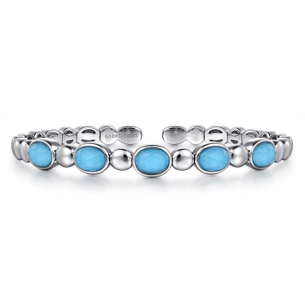 Silver bracelet with blue stones on a white background