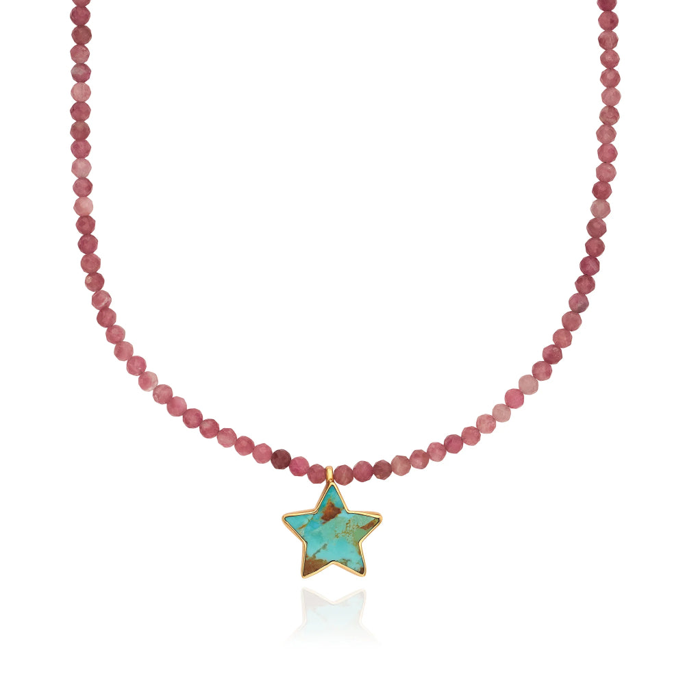 A beaded necklace featuring faceted dusty rose beads and a gold-trimmed star-shaped turquoise pendant, displayed against a clean white background.