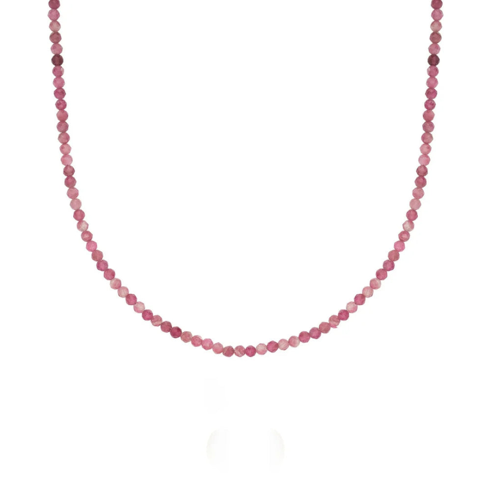 A delicate beaded necklace made of small faceted pink beads