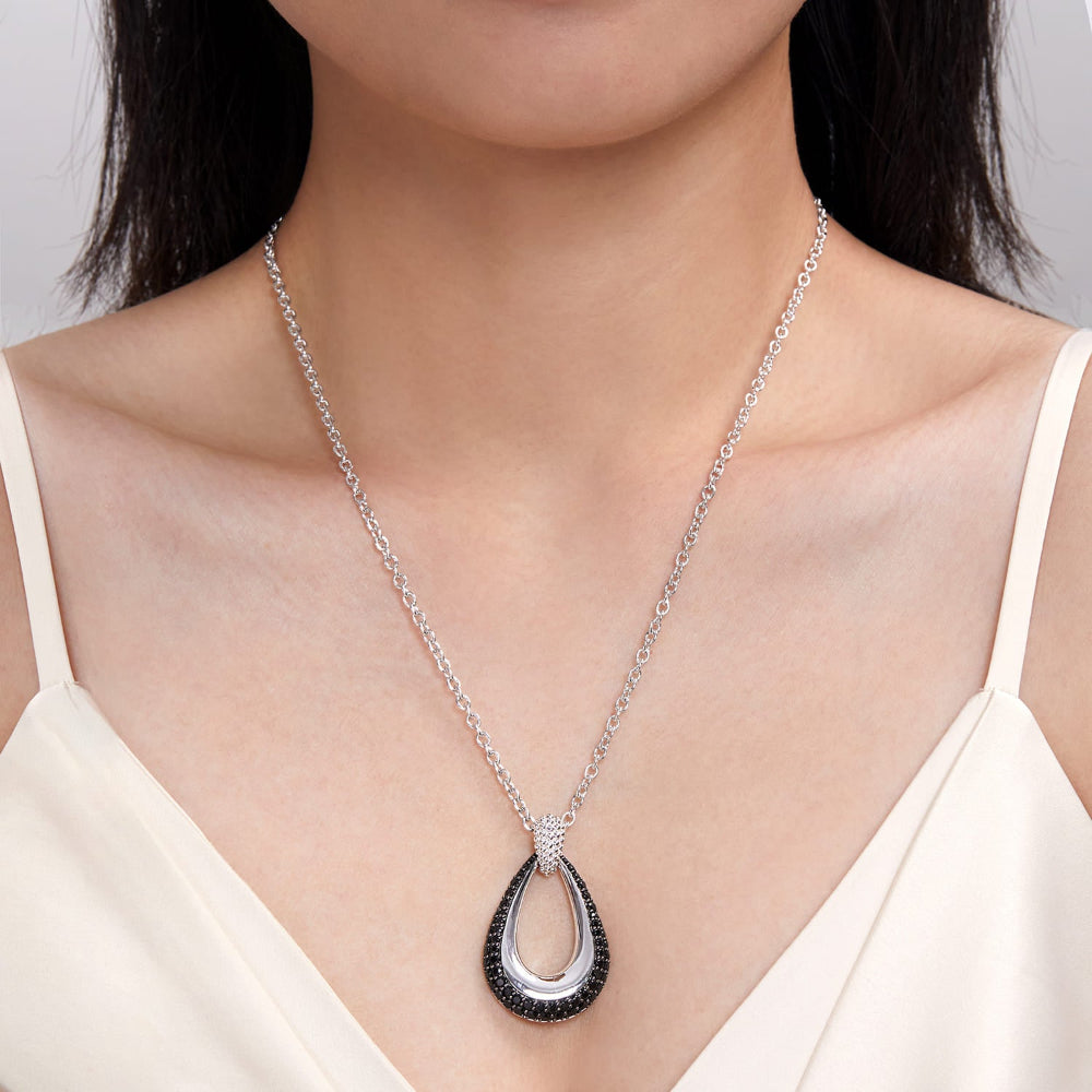 Person wearing silver and black spinel pendant necklace 