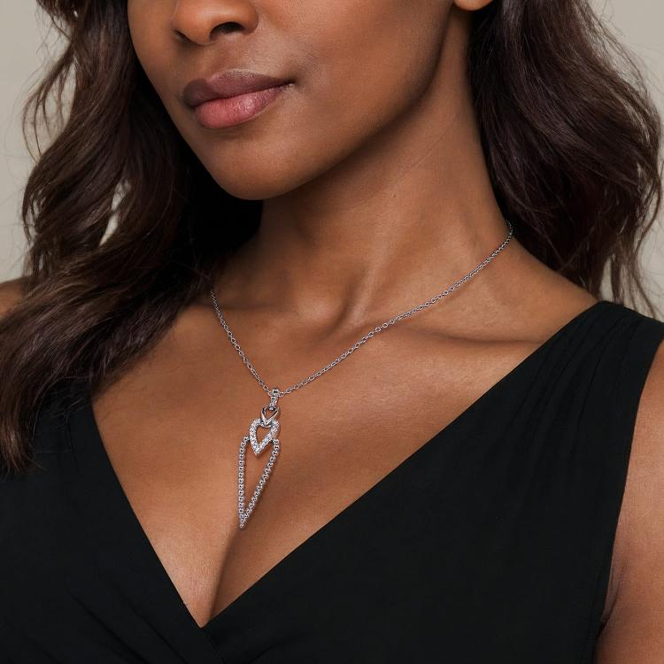 Woman wearing a silver necklace with a white sapphire and beads drop pendant 