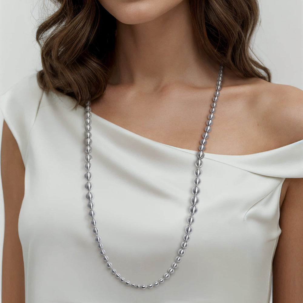 Woman wearing 32 in silver brush beaded necklace 