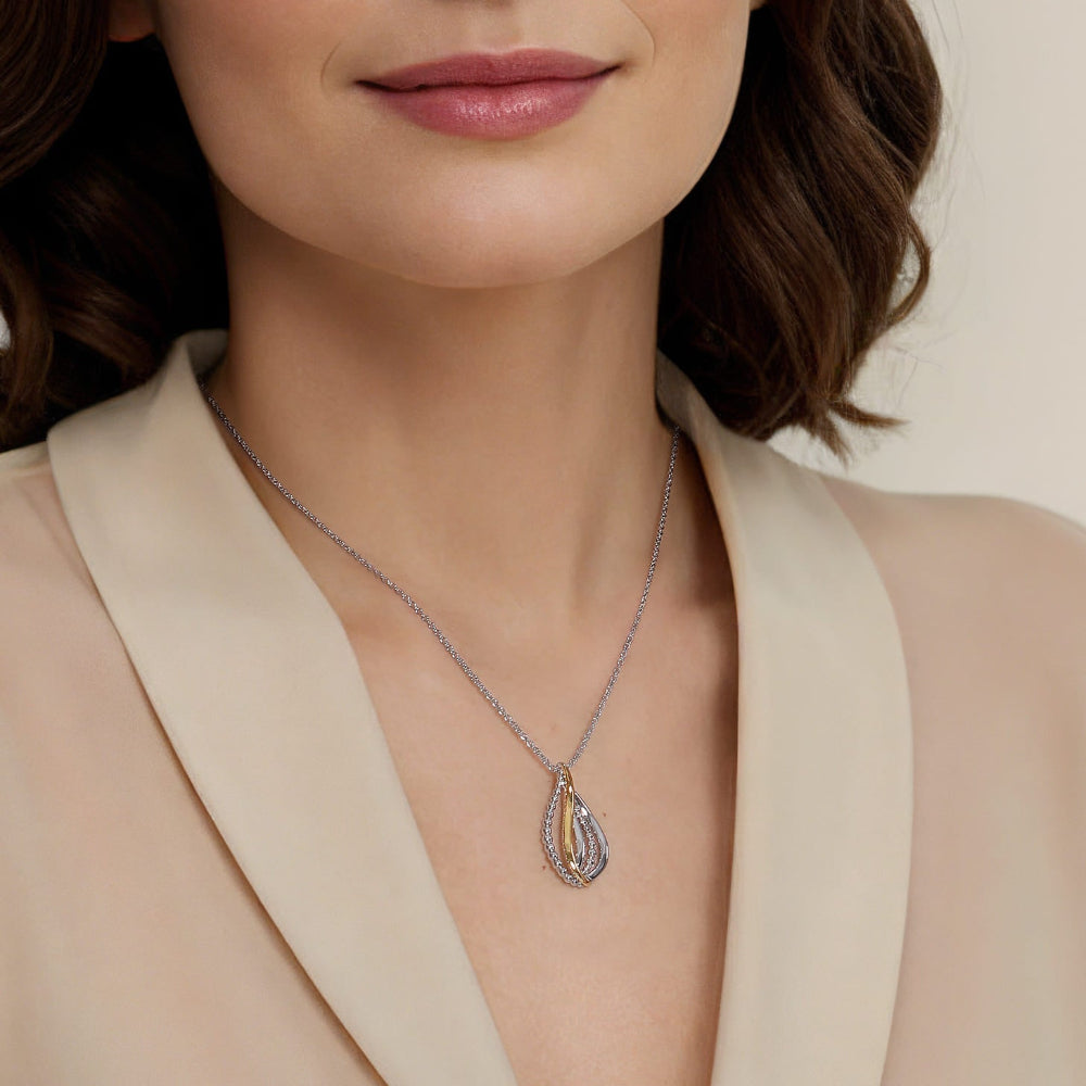 Woman wearing silver and gold twist pendant on silver 17.5 chain 