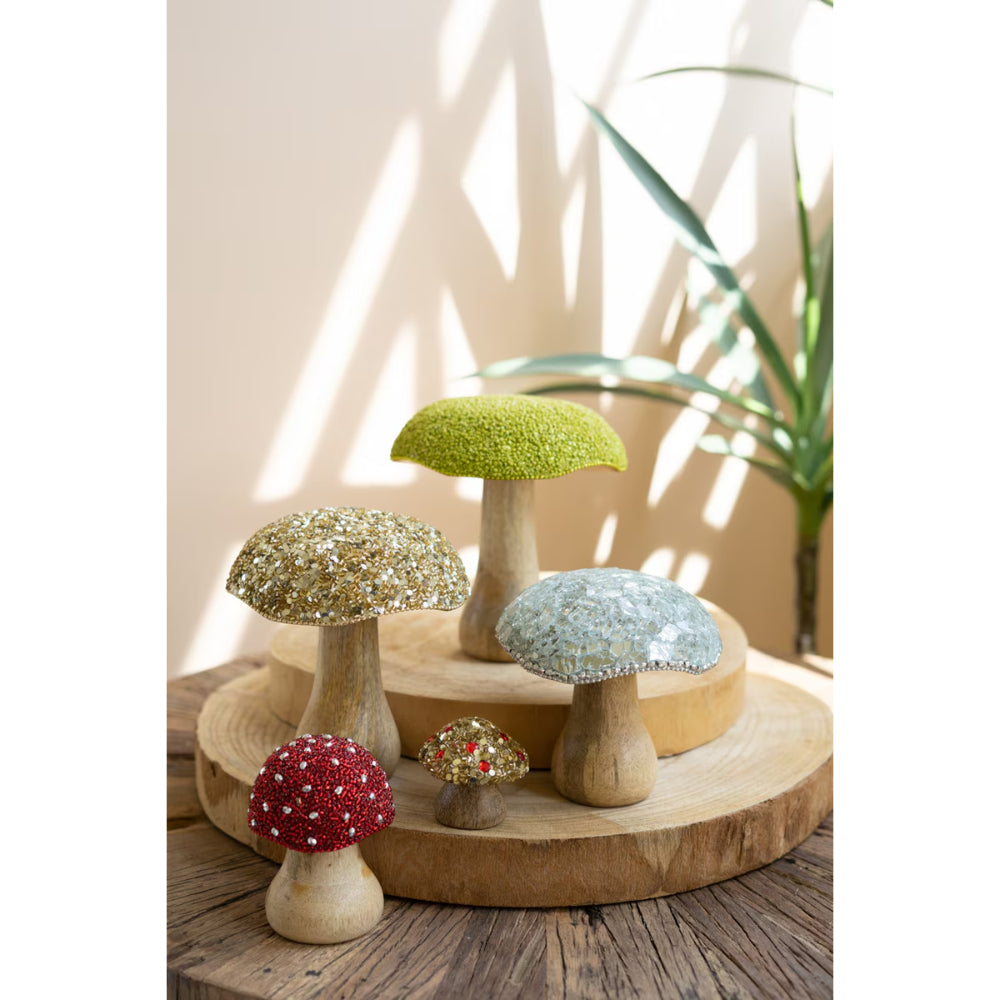 Decorative mushroom figurines with colorful caps on a wooden surface.