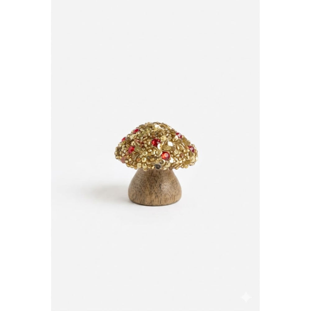 Decorative mushroom figurine with gemstones on a white background