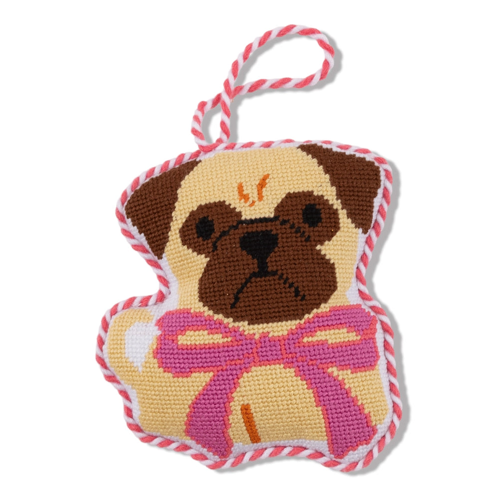 Cross-stitched dog ornament with a pink bow on a white background.