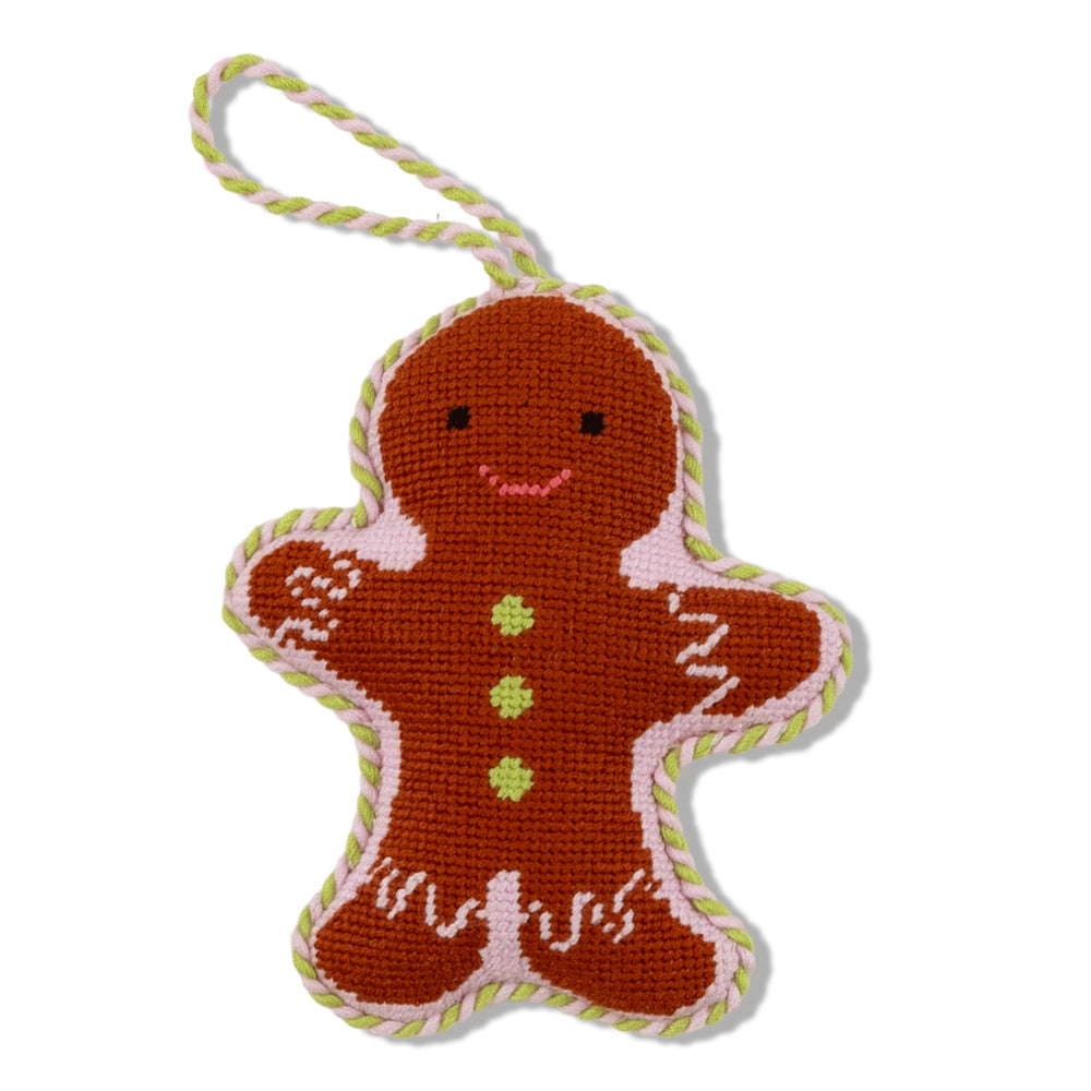 A brown gingerbread needlepoint ornament on a white backround. 