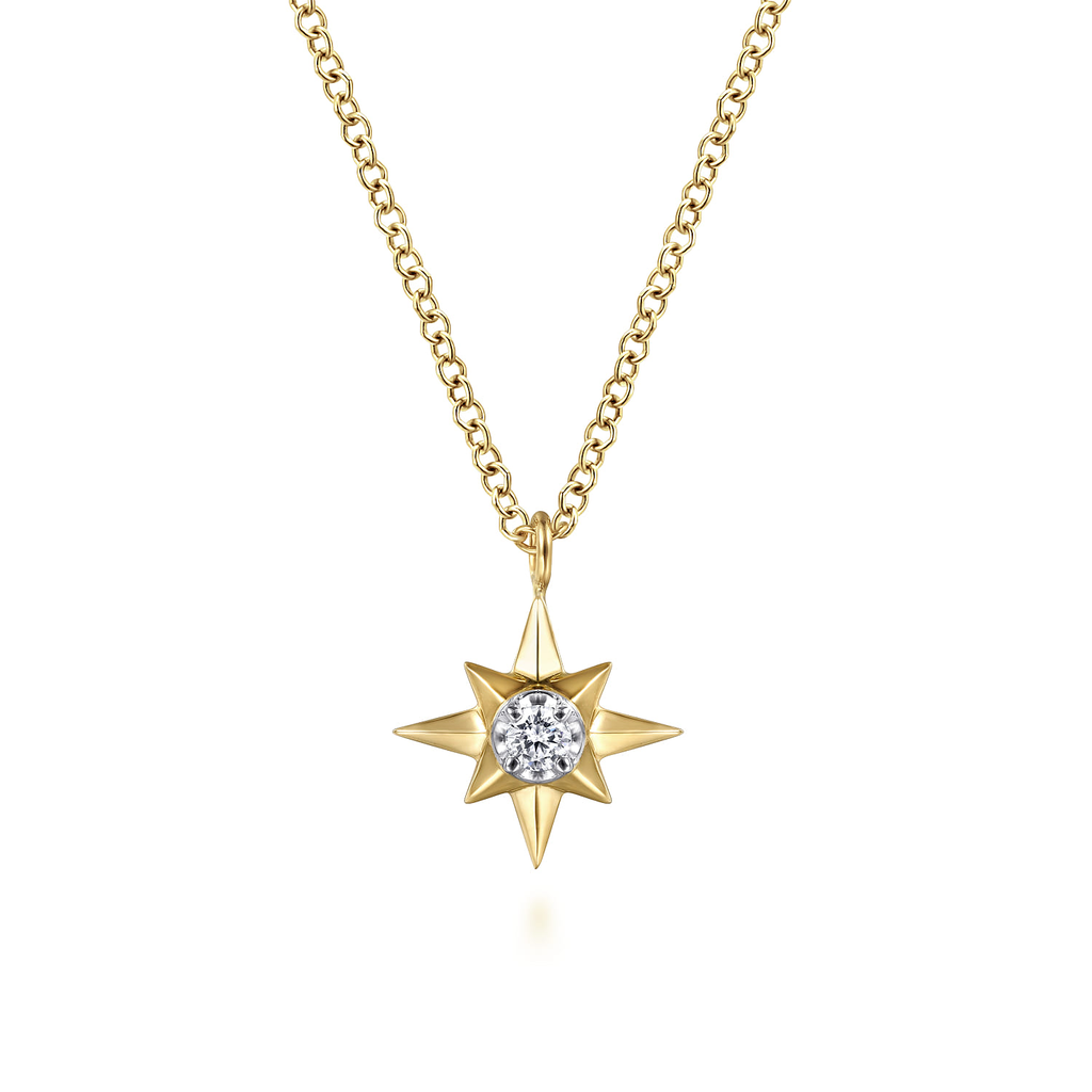Gold necklace with a star-shaped pendant on a white background