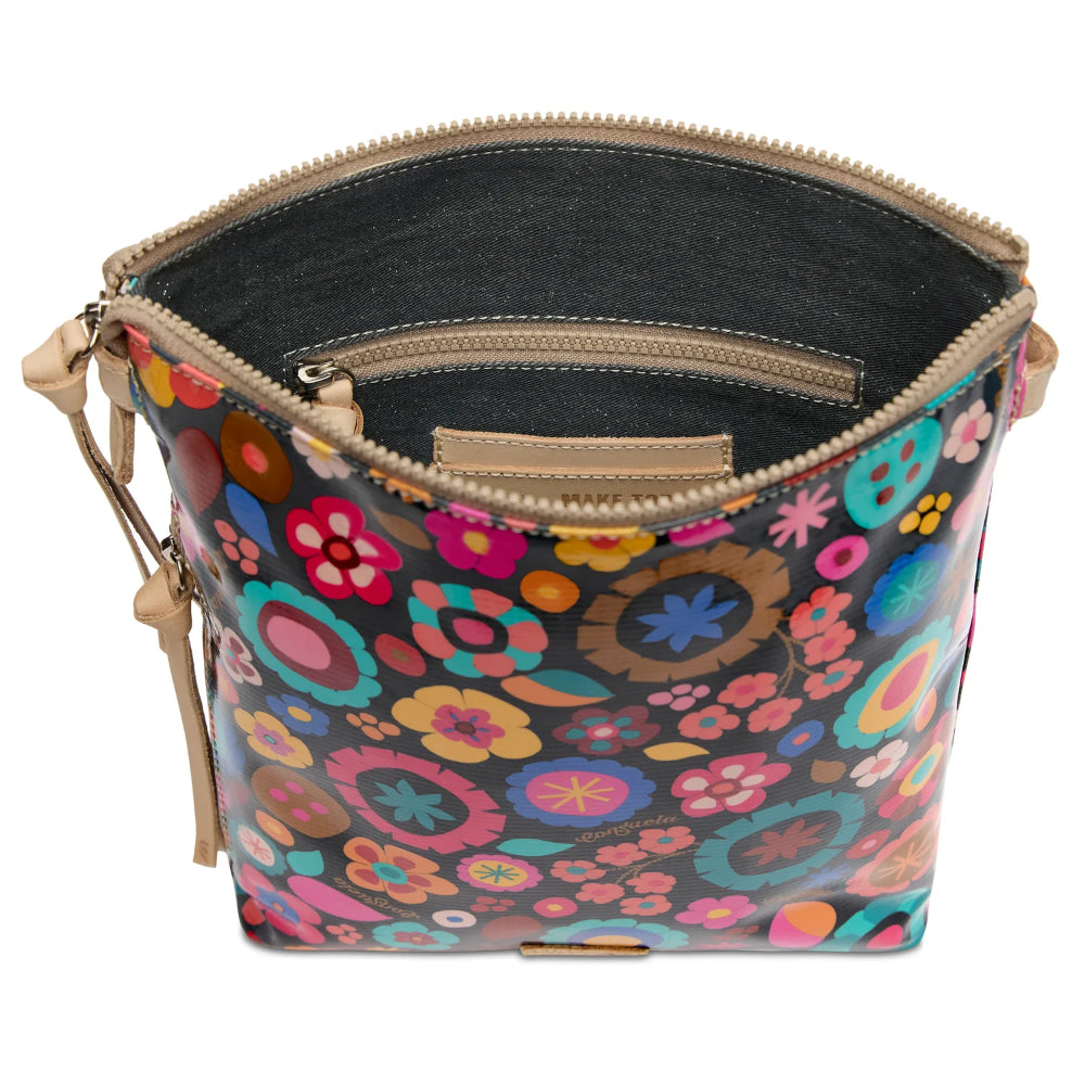 Colorful floral-patterned bucket bag with a beige interior and handle on a white background