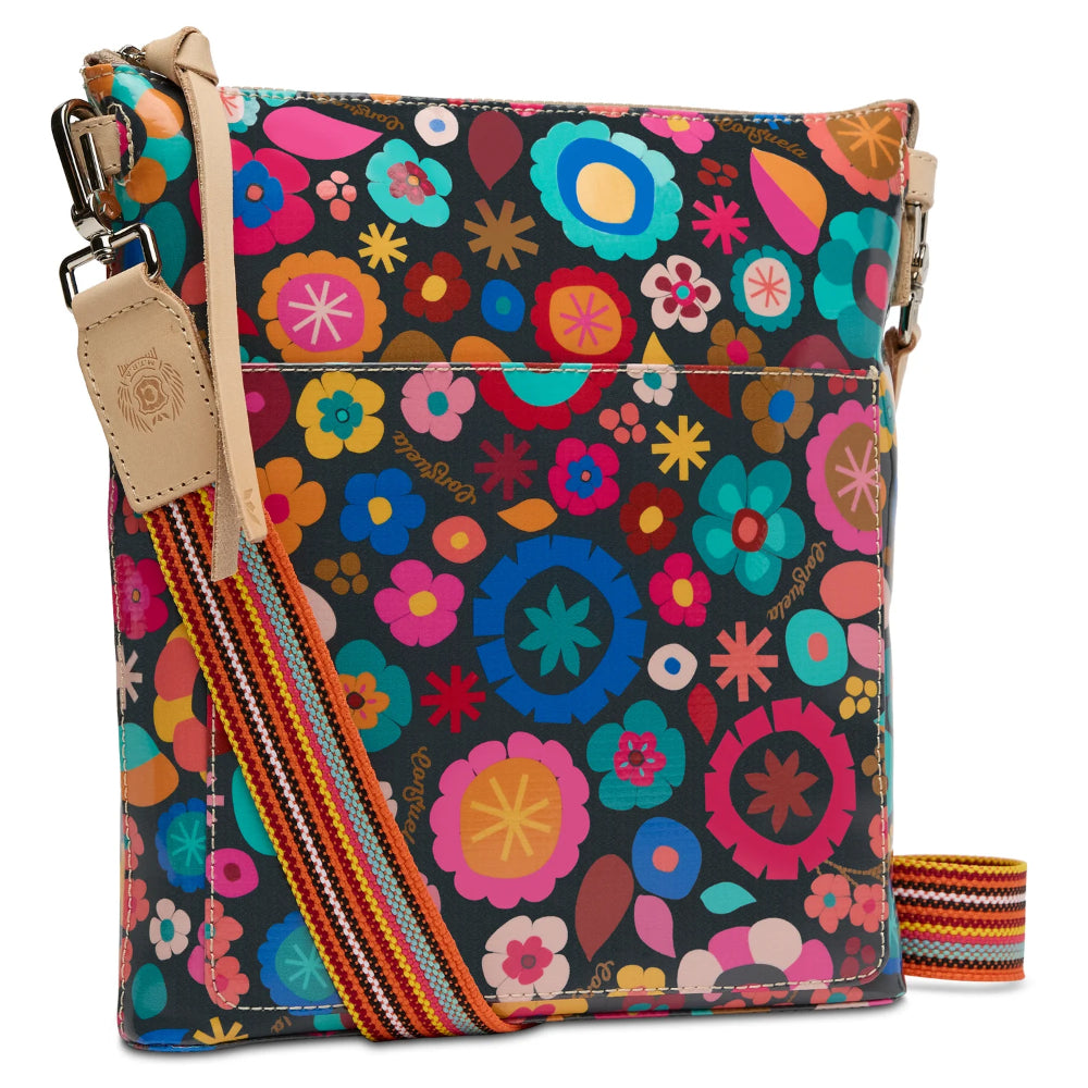 Floral patterned crossbody bag with colorful strap on a white background