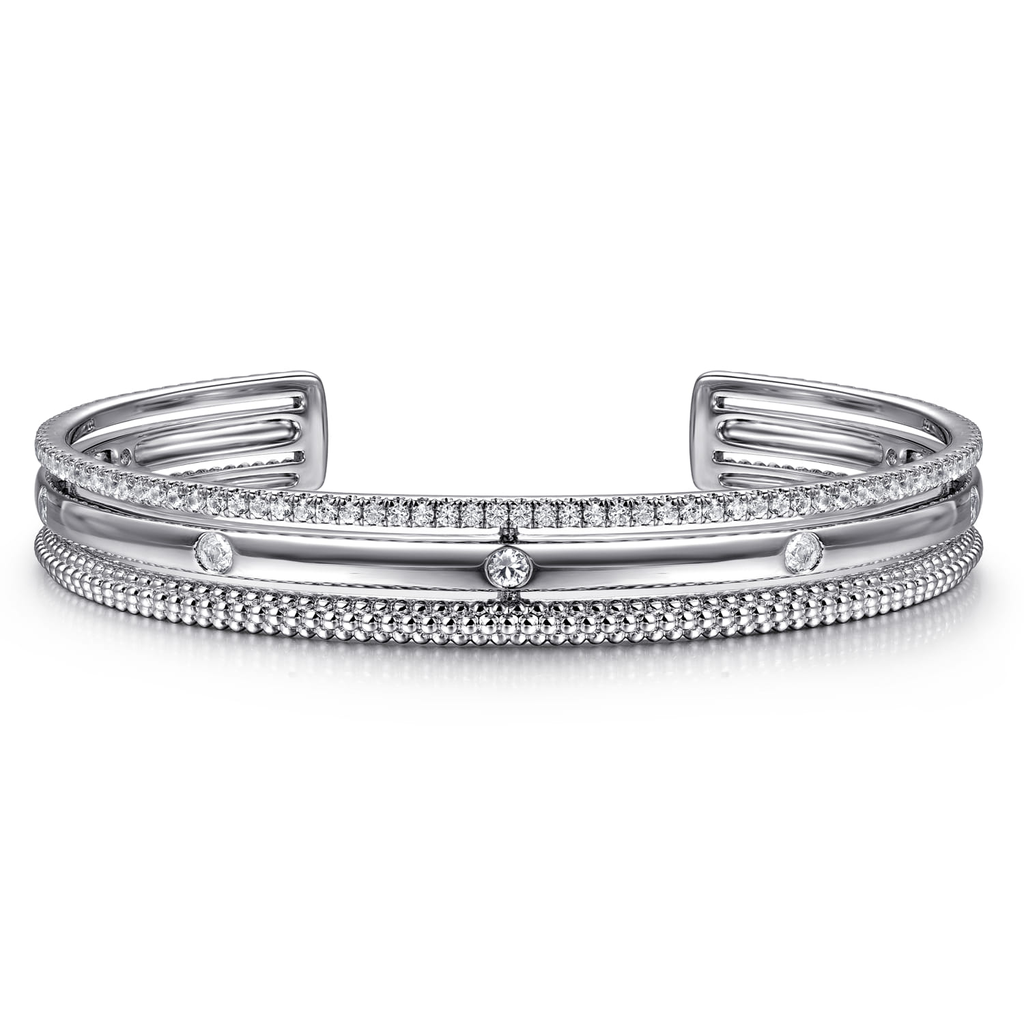 Silver bracelet with diamond accents on a white background