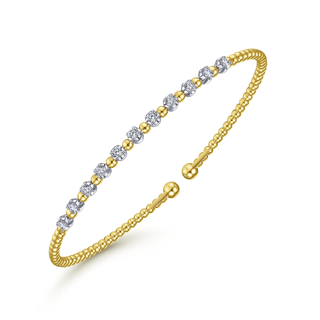yellow bracelet with clear stone stations on white background