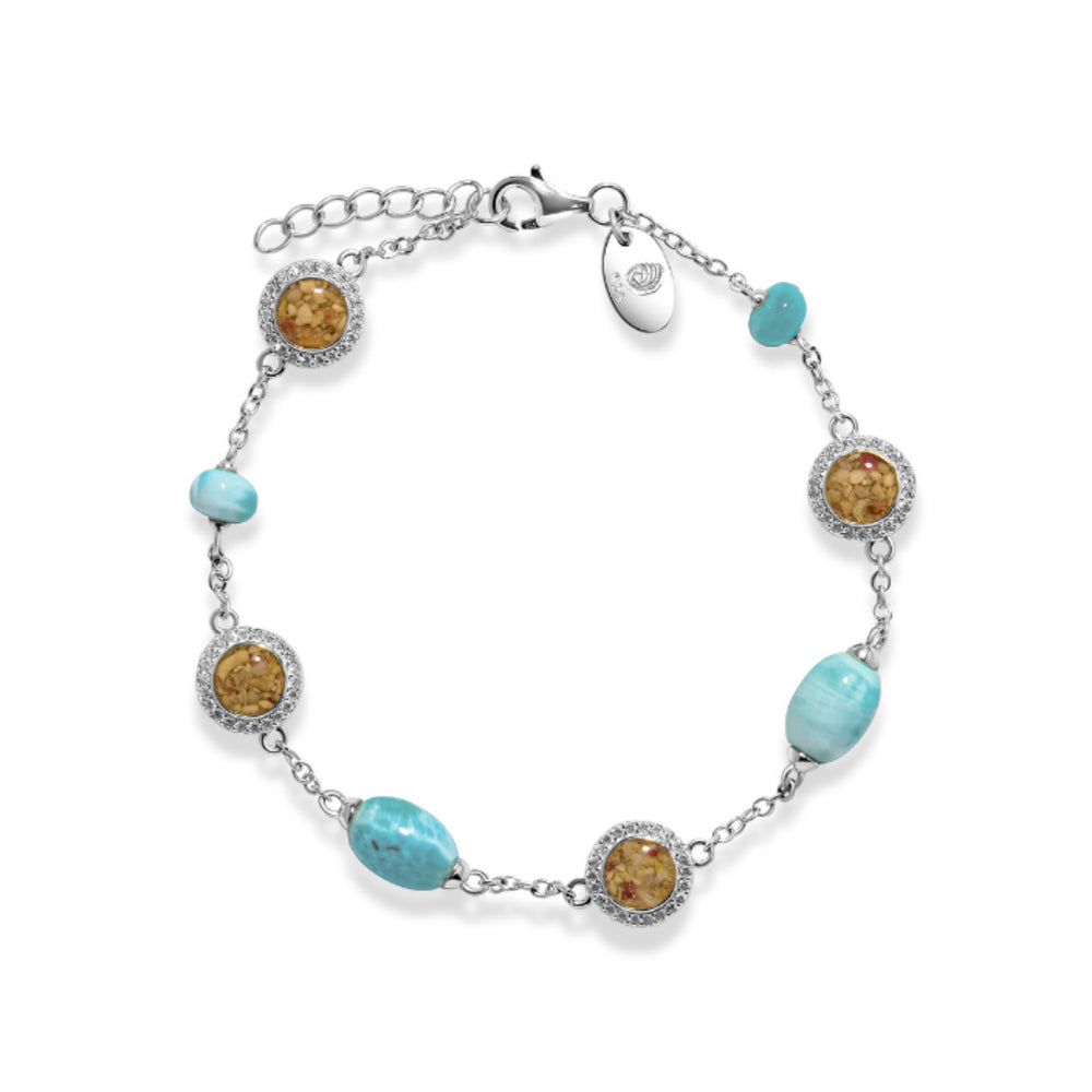 A silver chain bracelet featuring four round sand beads in halo settings and four light blue oval beads, displayed on a clean white background.