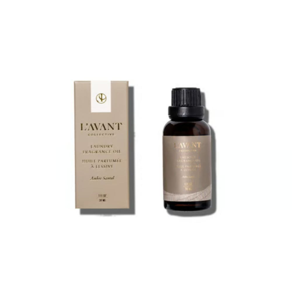 A bottle of L'Avant Collection 1 Hour Fragrance Oil next to its beige packaging box, set against a plain white background.