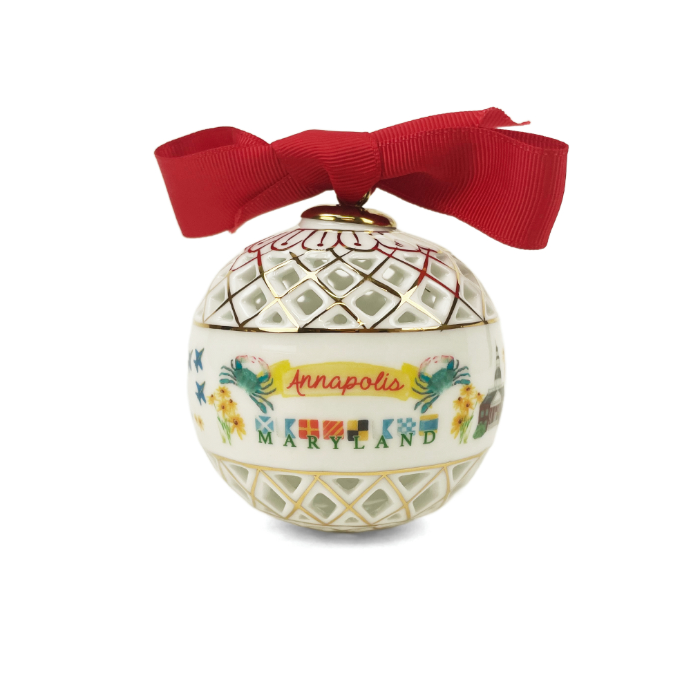 A ceramic Christmas ornament shaped like a white egg with gold lattice patterns, decorated with colorful illustrations and the text 'Annapolis MARYLAND,' topped with a red ribbon bow, on a white background.