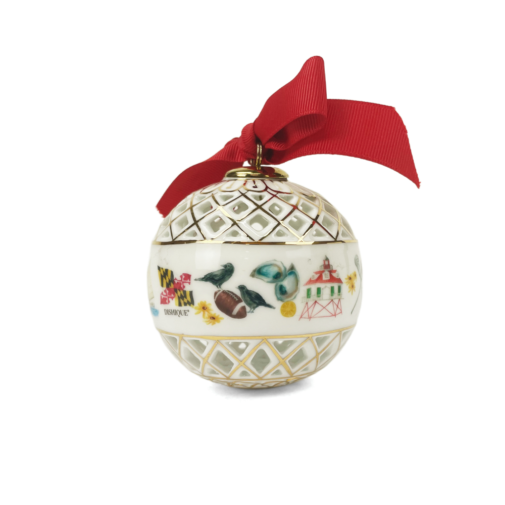 A white ceramic Christmas ornament with gold trim, featuring a hand-painted design of birds, a football, a lighthouse, and the Maryland state flag, topped with a red ribbon bow.
