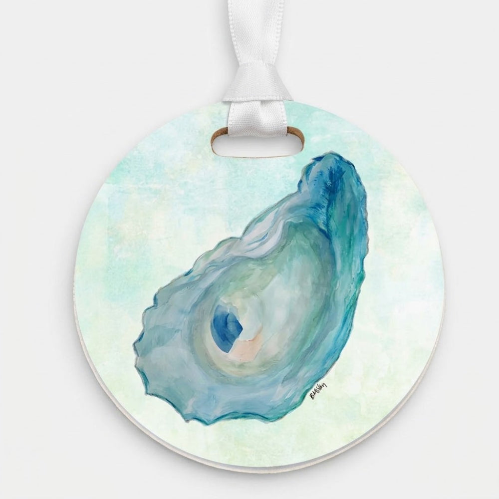 Round hanging ornament featuring a watercolor-style illustration of an oyster shell in shades of blue and teal on a pale mint background, with a white ribbon loop at the top.