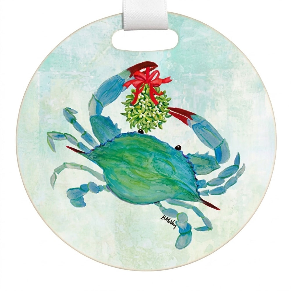 Round hanging ornament featuring a painted blue crab holding a green mistletoe with a red bow, on a pale aqua background. A white hanging ribbon is attached at the top.