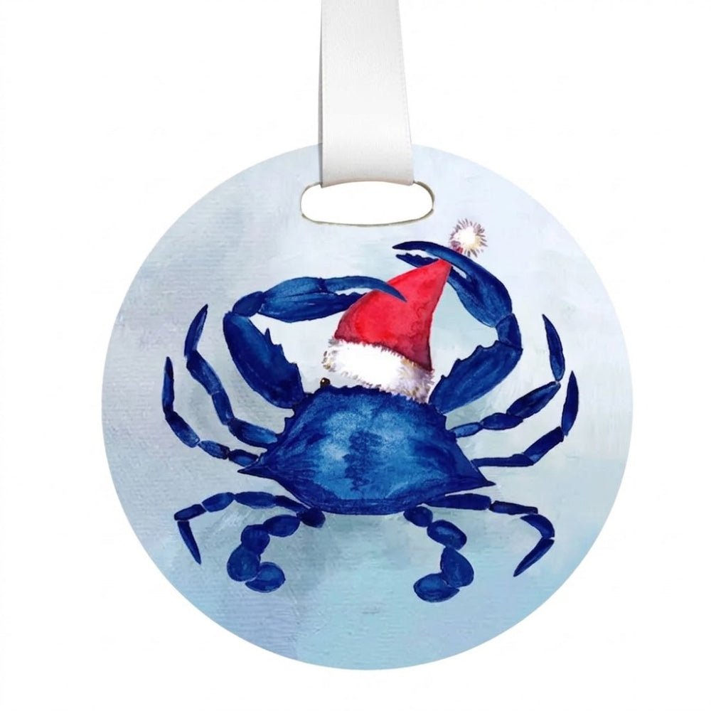 Round hanging ornament featuring a painted blue crab wearing a red Santa hat, with a white hanging ribbon at the top, shown on a plain white background.