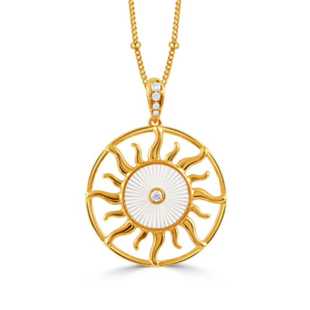 gold tone sun shape pendant on a gold tone chain with clear stones on a white background