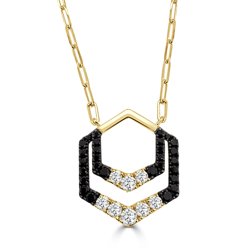 Gold necklace with a black and white diamond hexagon shaped pendant on a white background