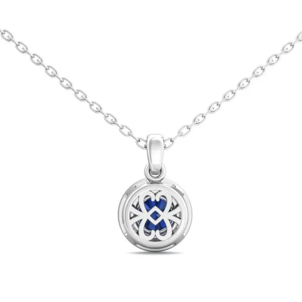 White gold necklace with a round blue sapphire center and surrounding diamond halo on a white background