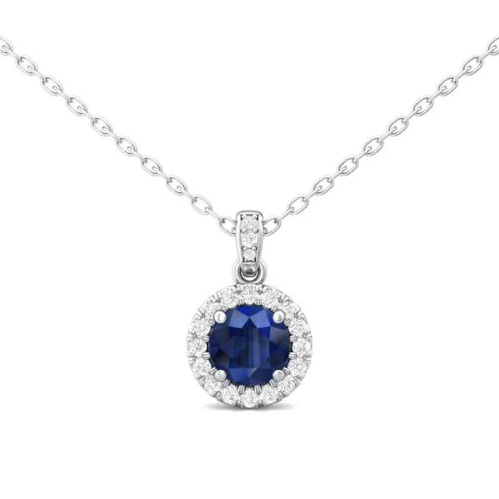 White gold necklace with a round blue sapphire center and surrounding diamond halo on a white background
