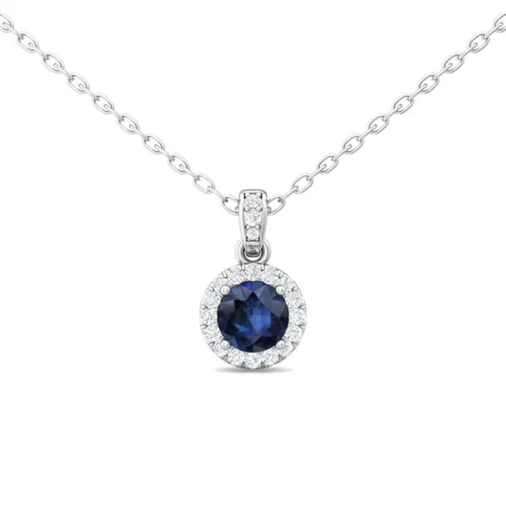 White gold necklace with a round blue sapphire center and surrounding diamond halo on a white background