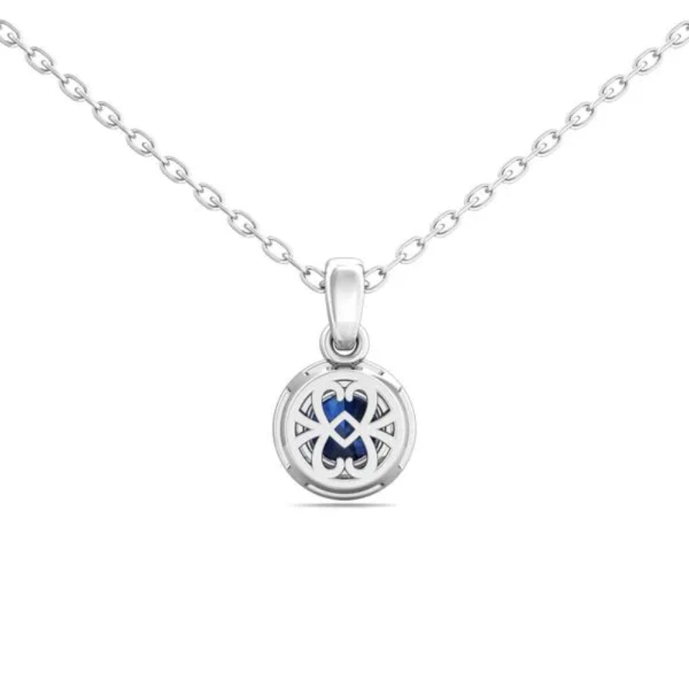 White gold necklace with a round blue sapphire center and surrounding diamond halo on a white background
