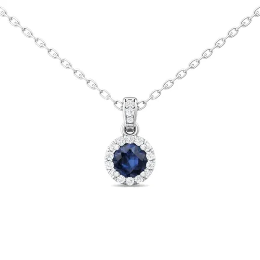 White gold necklace with a round blue sapphire center and surrounding diamond halo on a white background