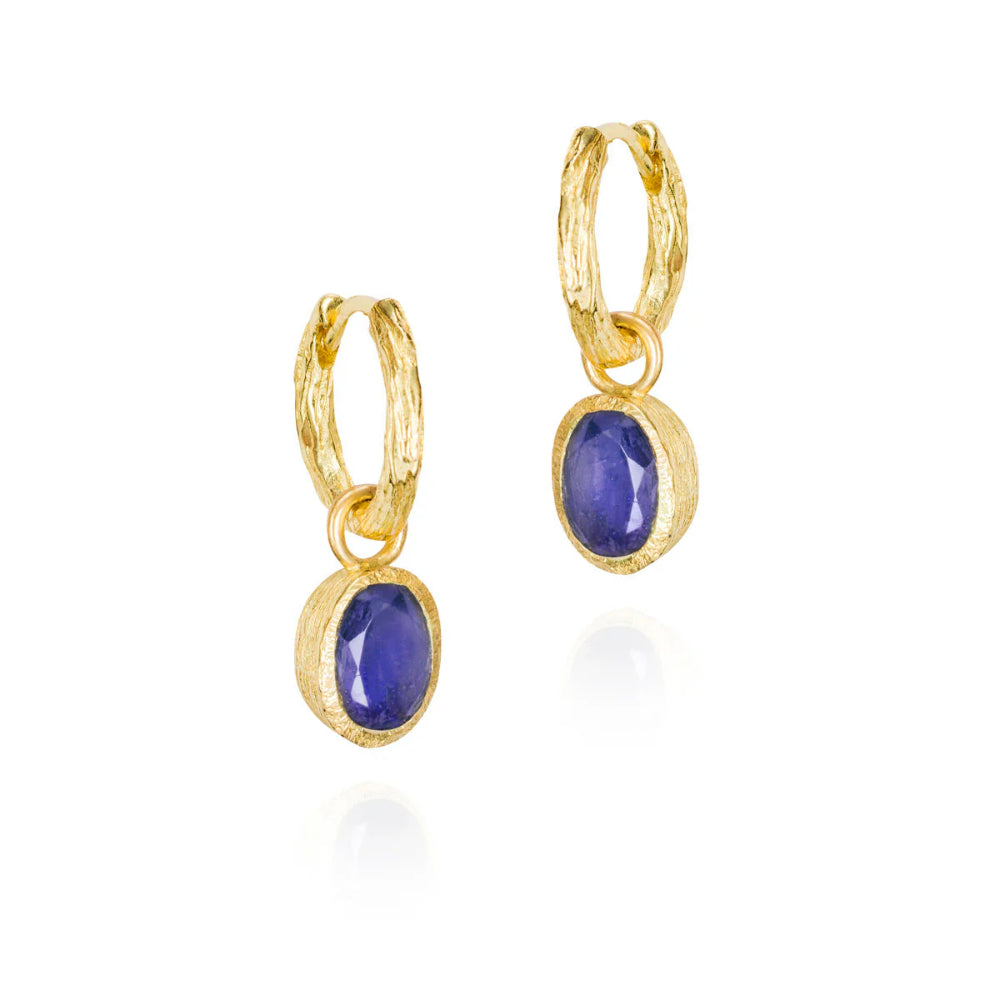 A pair of elegant drop earrings with blue sapphire stones, gold vermeil textured bands and artisanal hoops.