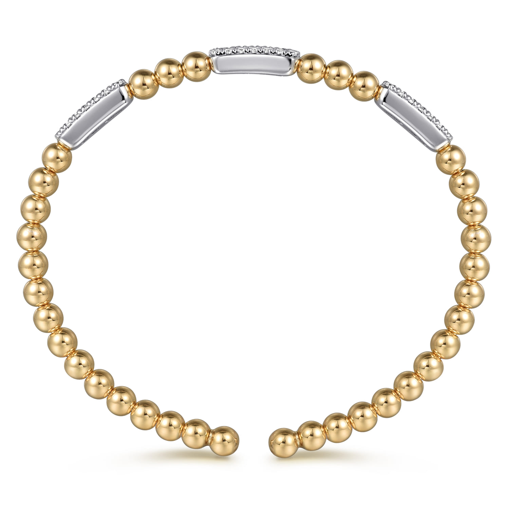 gold beaded bangle with clear stones on white background