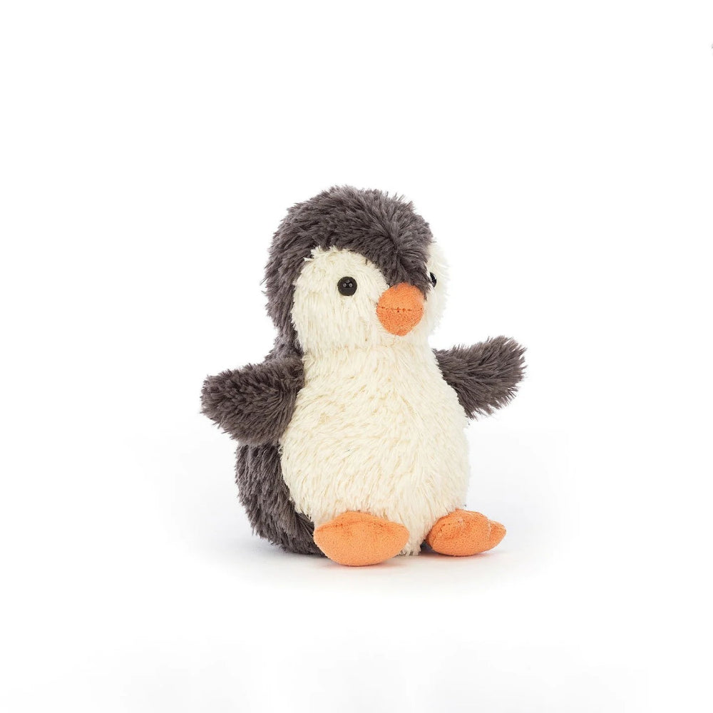 Small stuffed penguin toy on a white background
