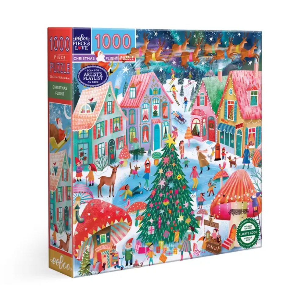 A 1000-piece jigsaw puzzle box featuring a colorful Christmas village scene with houses, a decorated Christmas tree, sleighs, and festive people. The box is shown at a slight angle against a plain white background.