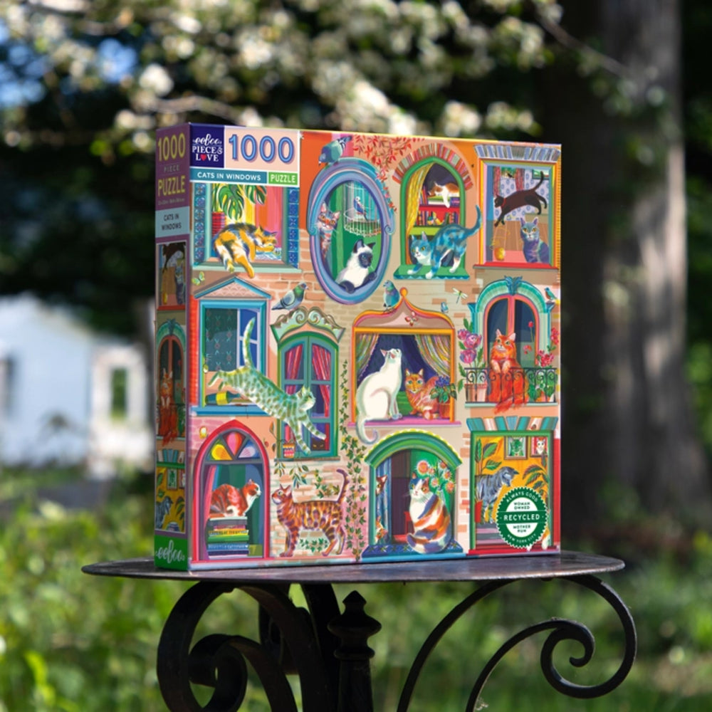 Colorful puzzle box with cat-themed design on a stand outdoors