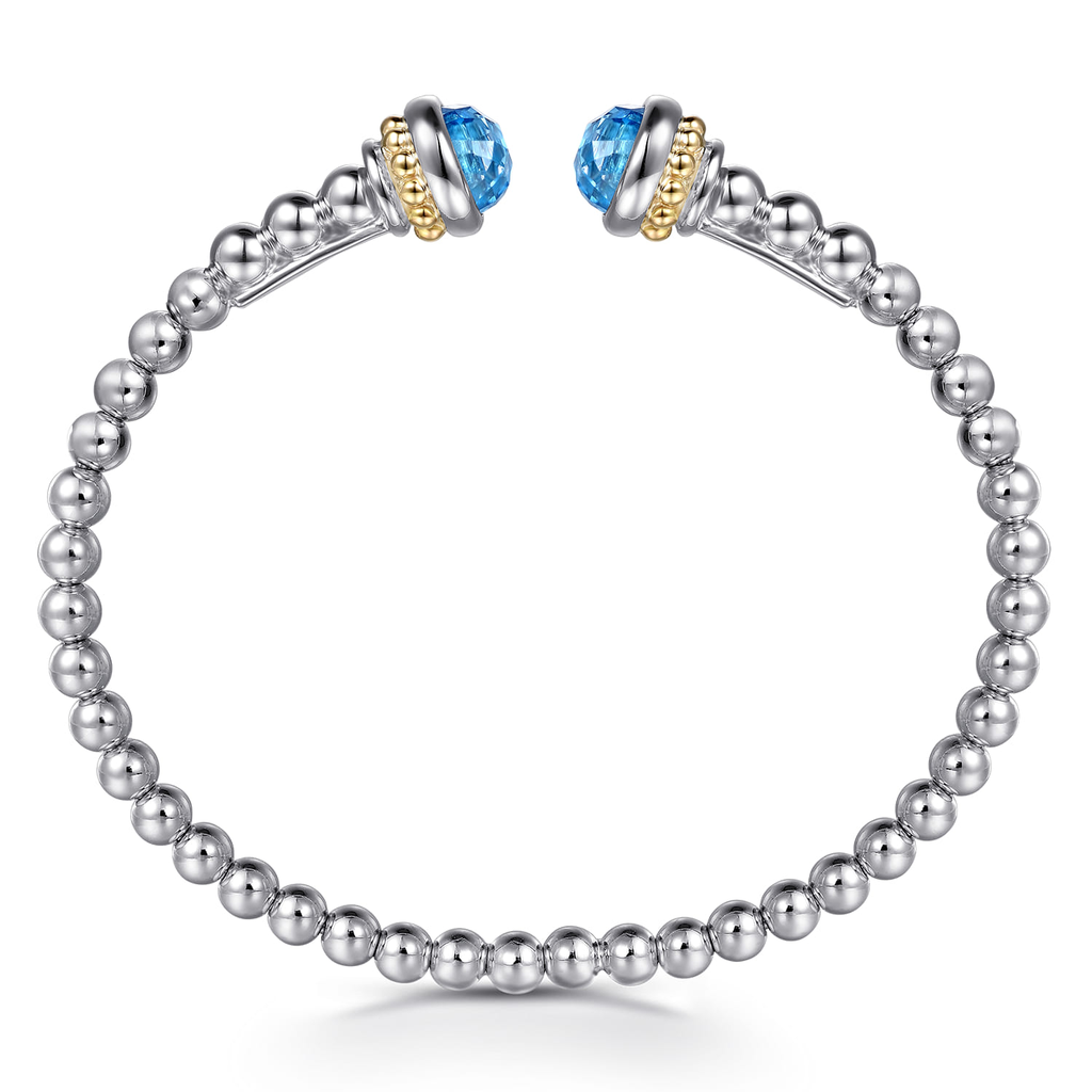Silver beaded bracelet with blue gemstone charms on a white background