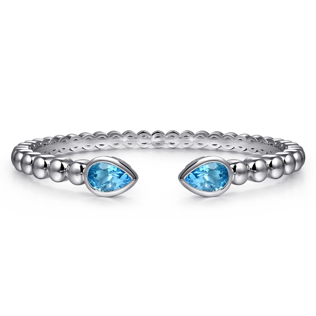 Silver ring with blue gemstones on a white background