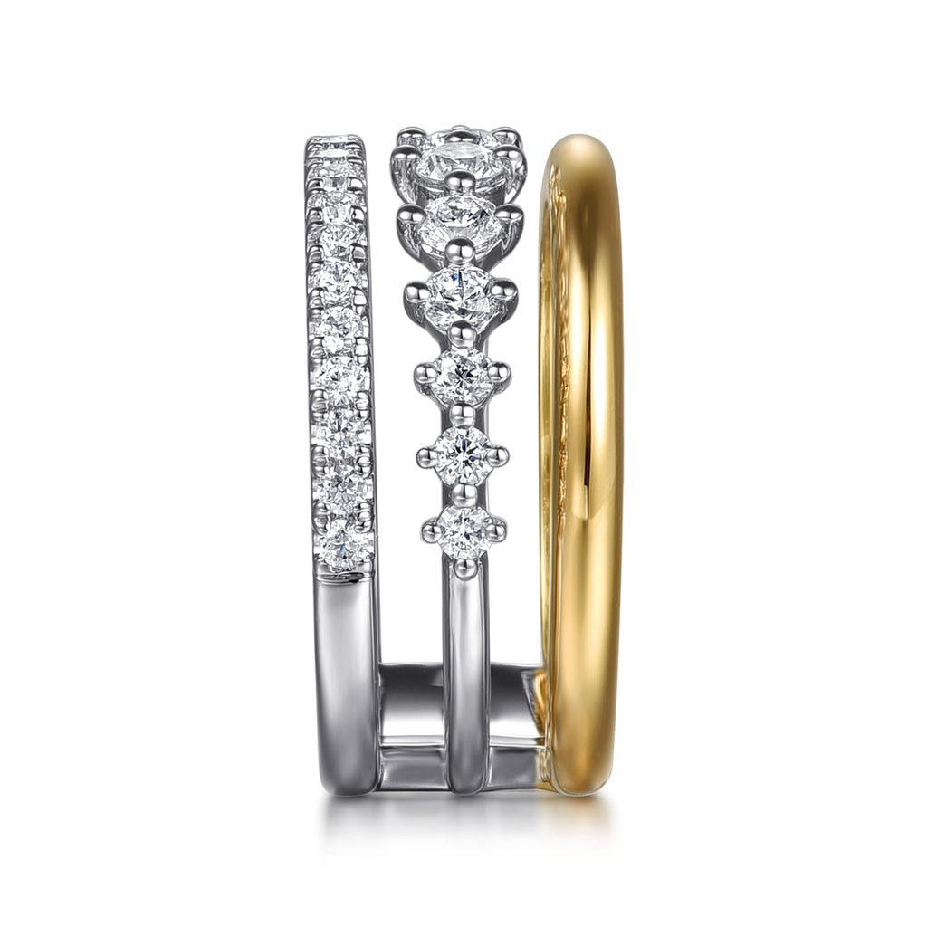 gold and silver triple band with clear stones on white background