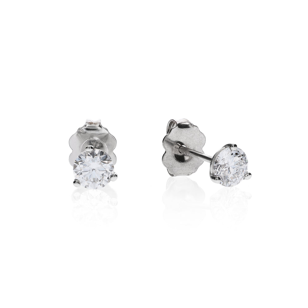 White gold 3 prong martini set diamond studs on a white background