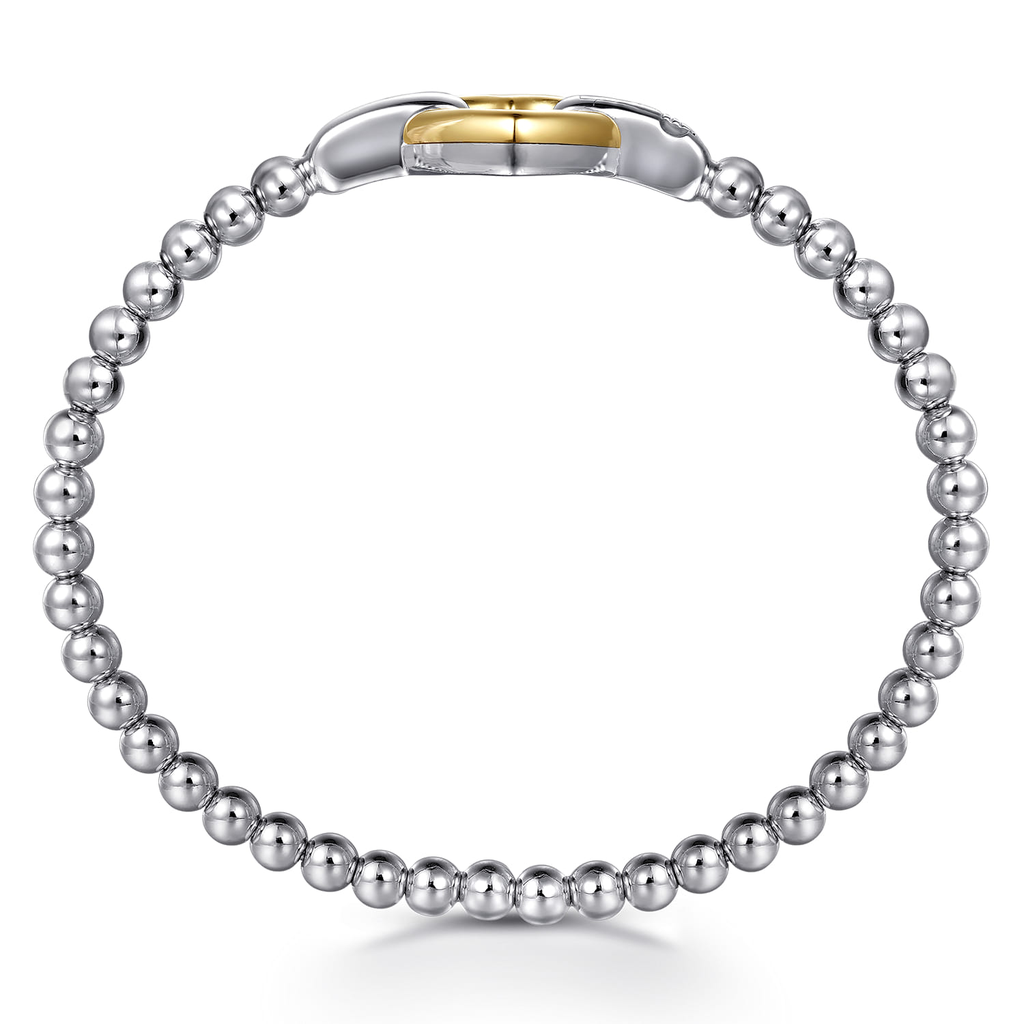 Silver beaded bracelet with a gold clasp on a white background