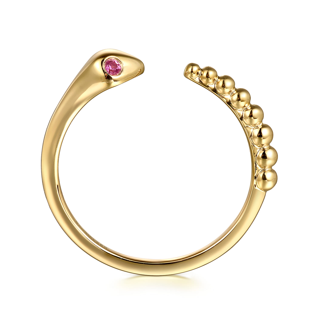Gold ring with a pink gemstone on a white background
