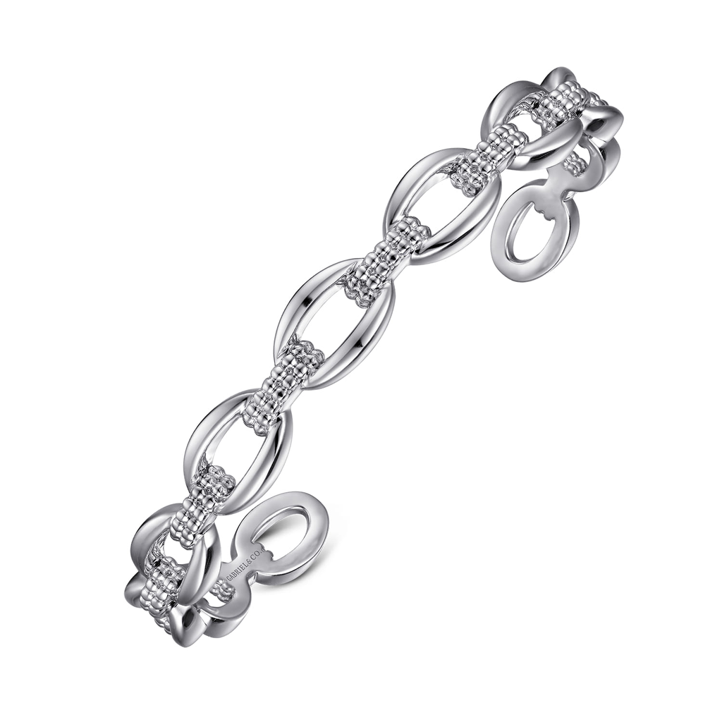 Silver bracelet with intricate design on a white background