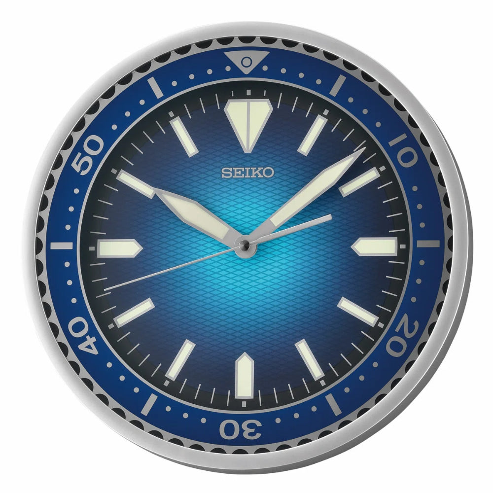 A round Seiko wall clock with a blue sunburst dial, a blue bezel with white numerals, and a silver-toned outer rim, shown against a plain white background.