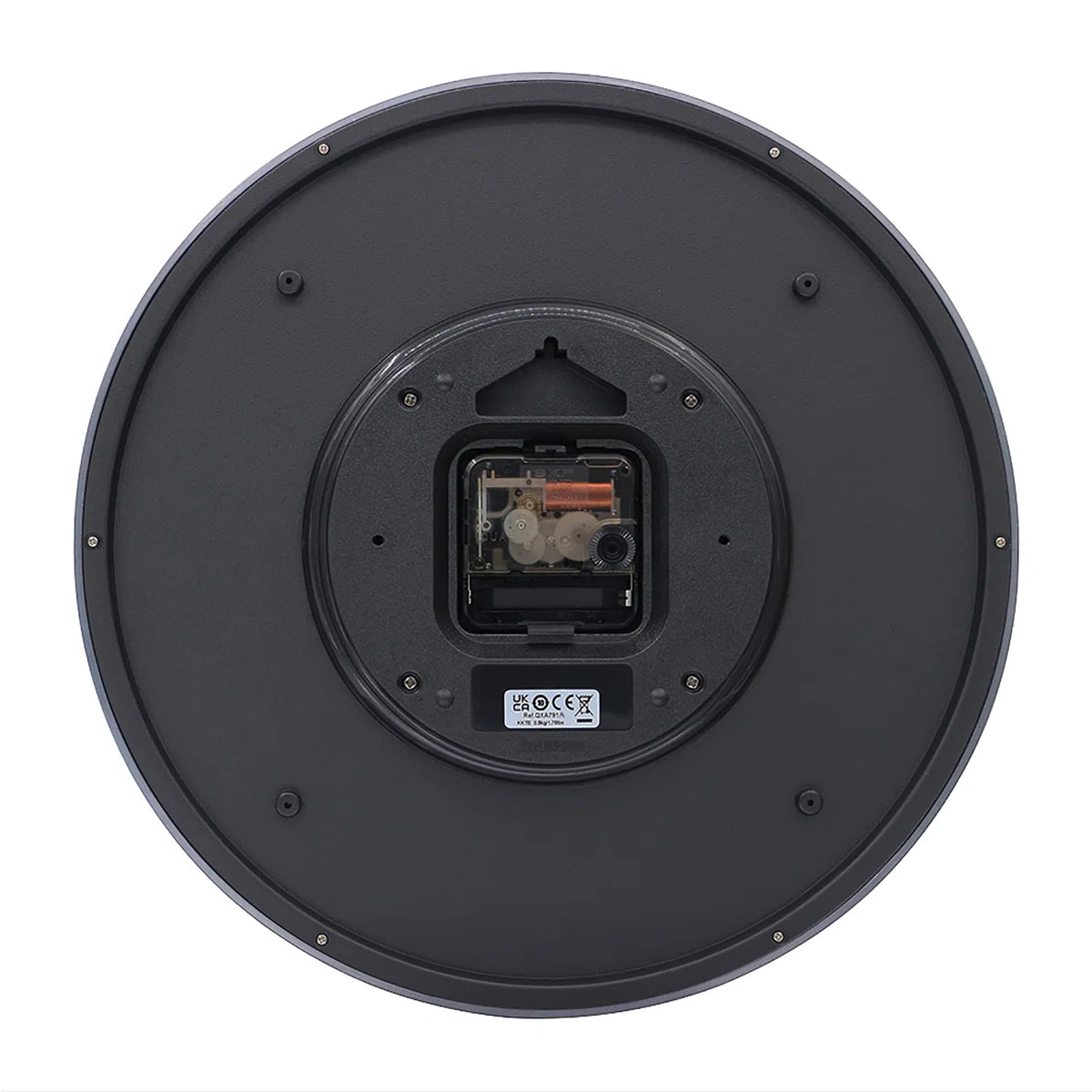 The underside of a circular black speaker, showing the internal driver components and a small label with CE certification marks, isolated on a white background.