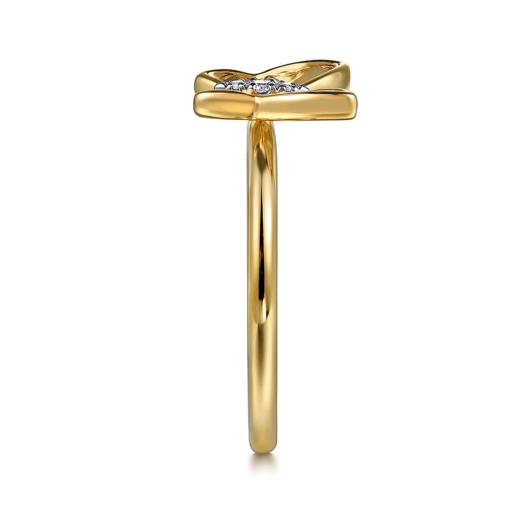 Gold ring with a bow design on a white background