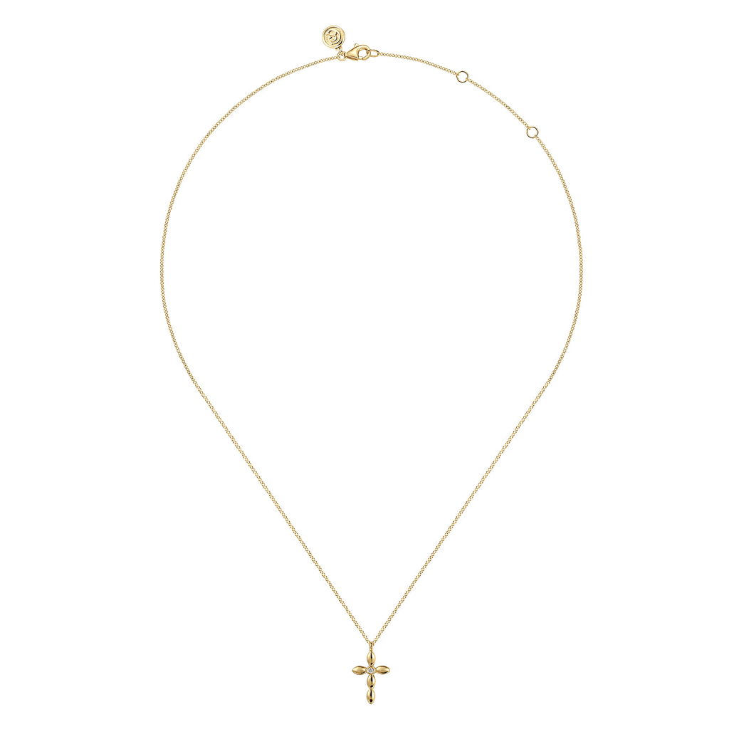 A delicate gold chain necklace with a small cross pendant, displayed on a clean white background.
