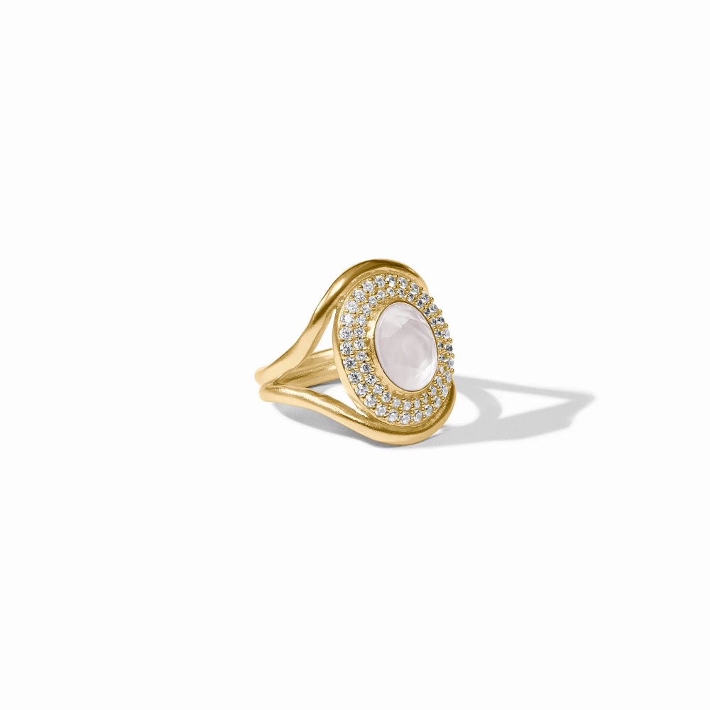 Gold ring with a circular design and embedded stones on a white background