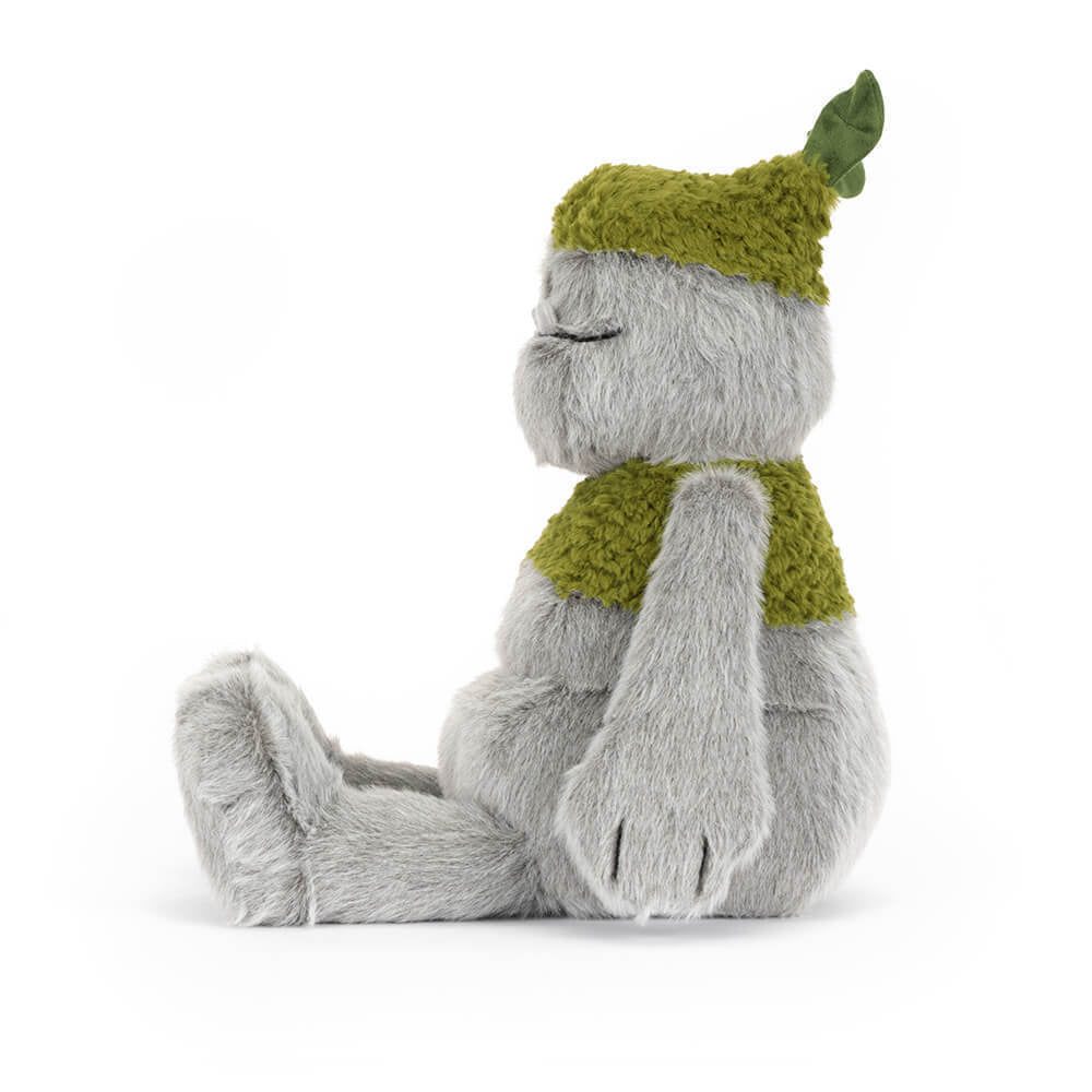 A side photo of a grey & green Rocketon plush toy creature on a white background.